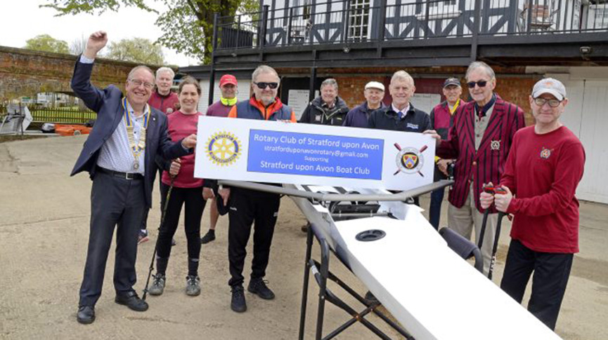 Rowers with Rotary Club banner